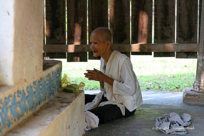Molto vecchia suora che prega al Wat Roka Kandal Kracheh (Kratie) - Cambogia