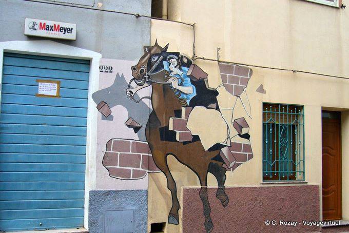 Orgosolo, il cavaliere rompendo il muro (Dopo Il Palio), a murale - Sardegna