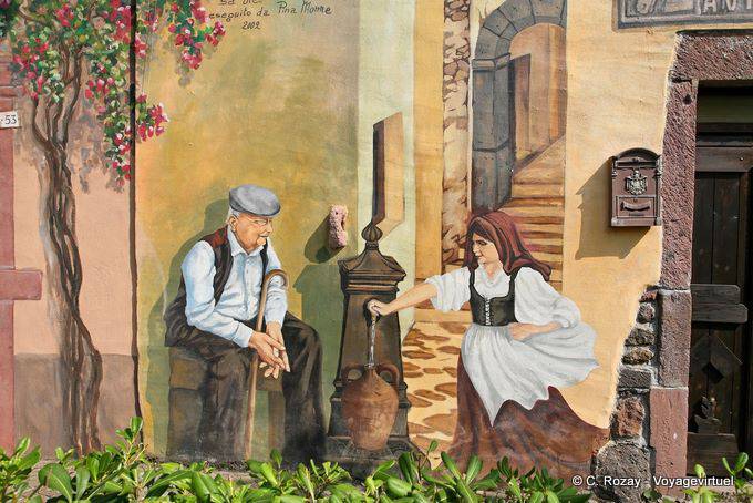 Tinnura, una discussione alla fontana, murale - Sardegna