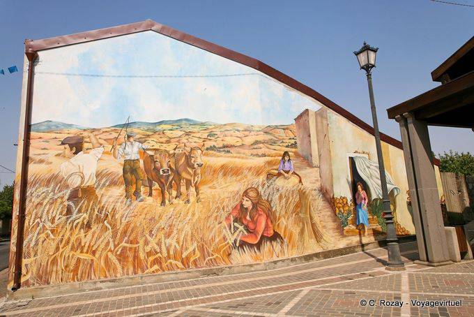 Tinnura, raccolta di mais, murale, Piazza del Municipio - Sardegna