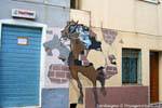 Orgosolo, il cavaliere rompendo il muro (Dopo Il Palio), a murale, Sardegna.