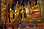 Buddha in piedi ai piedi di Phra Buddha Chinnarat, Wat Phra Si Rattana Mahatha, Phitsanulok, La Tailandia.