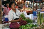 Commessa seduto nel mercato loto Sukhothai, La Tailandia.